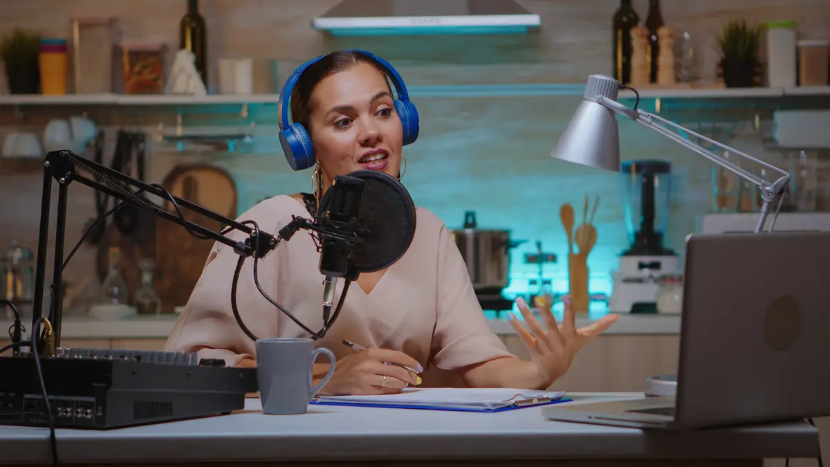 Influencer taking notes on clipboard while talking with followers during live on social media. Creative online show On-air production internet broadcast host streaming live content, recording digital