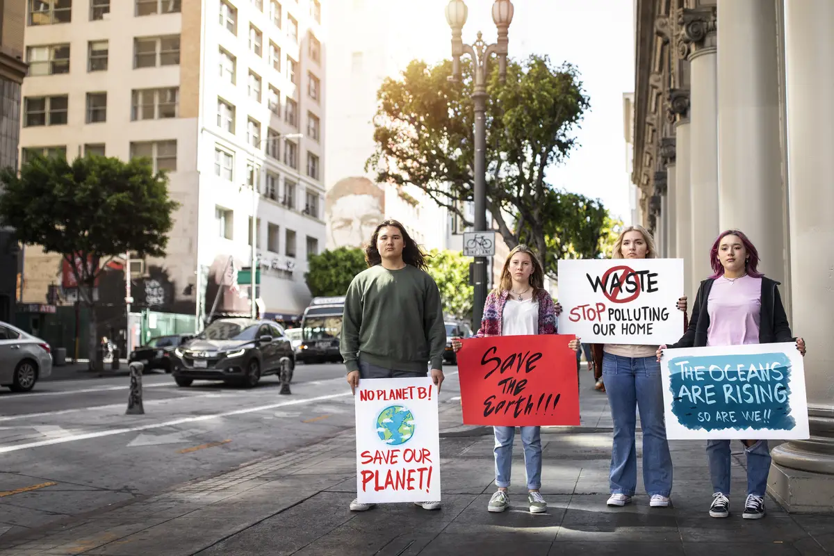 People at a world environment day protest outdoors with placards