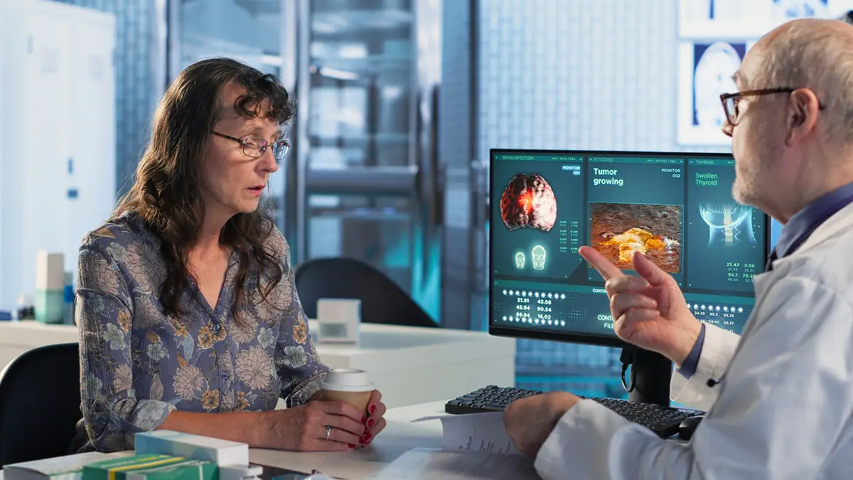 Physician and patient discuss x ray and MRI scan focusing on preventive medicine