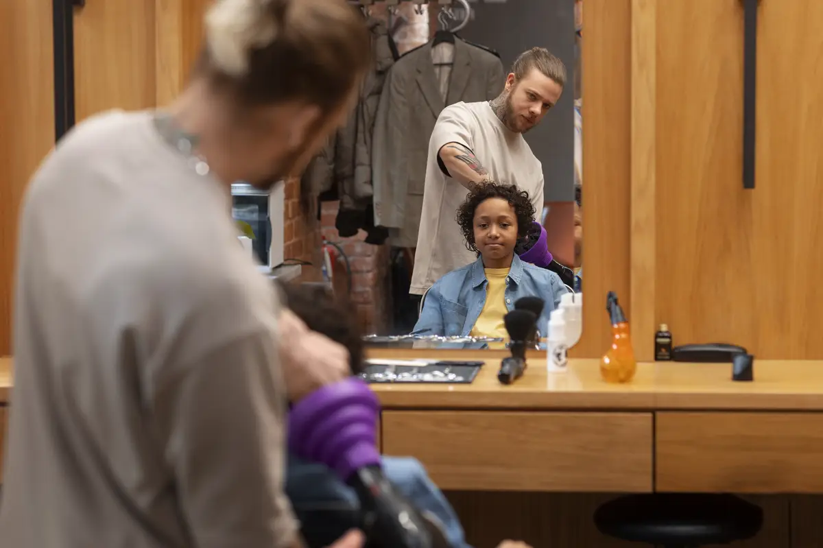 Child getting their hair blown at the salon