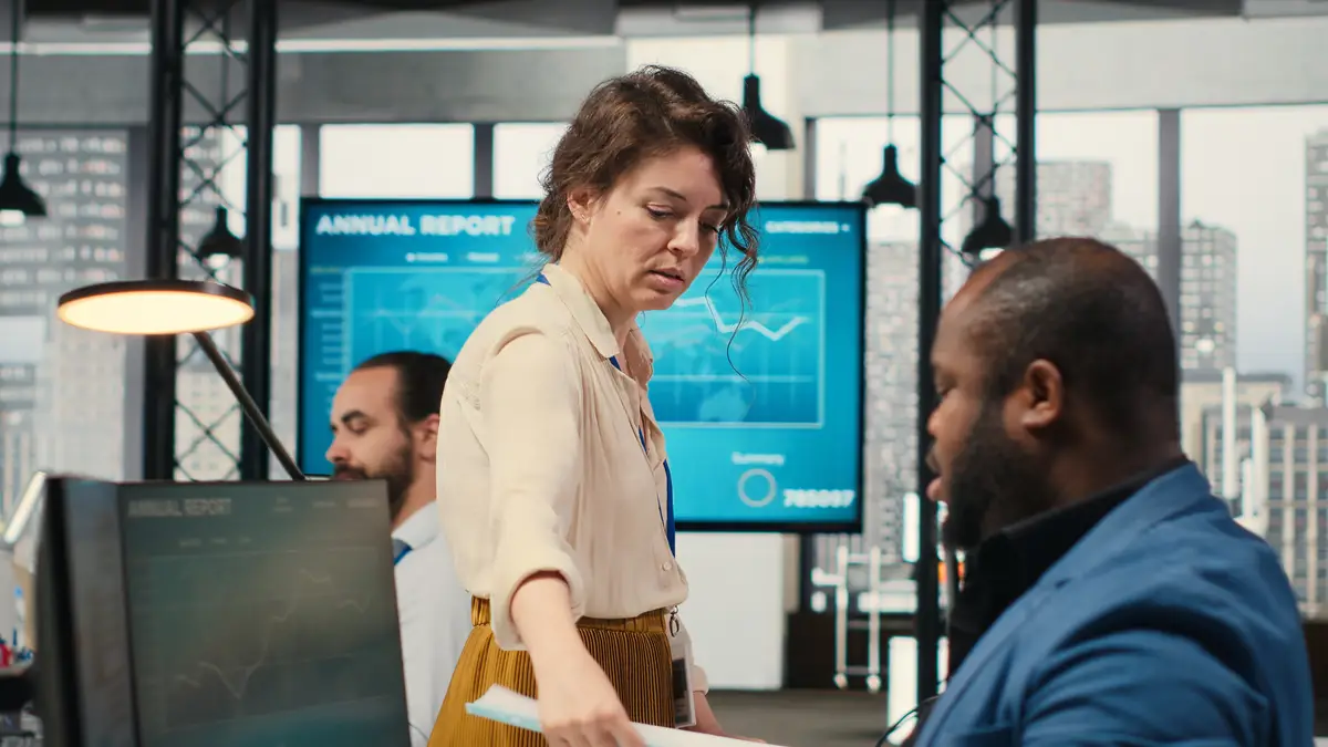 Woman secretary in an office pushes a trolley filled with paperwork