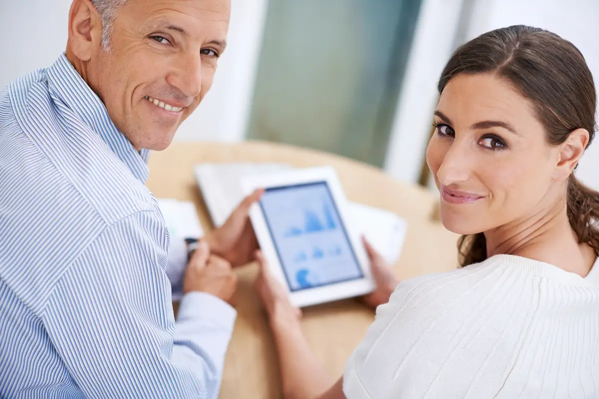 Portrait man and woman in office on tablet for sales review growth or development online Planning strategy and business people at desk on digital app for data analysis feedback or profit report