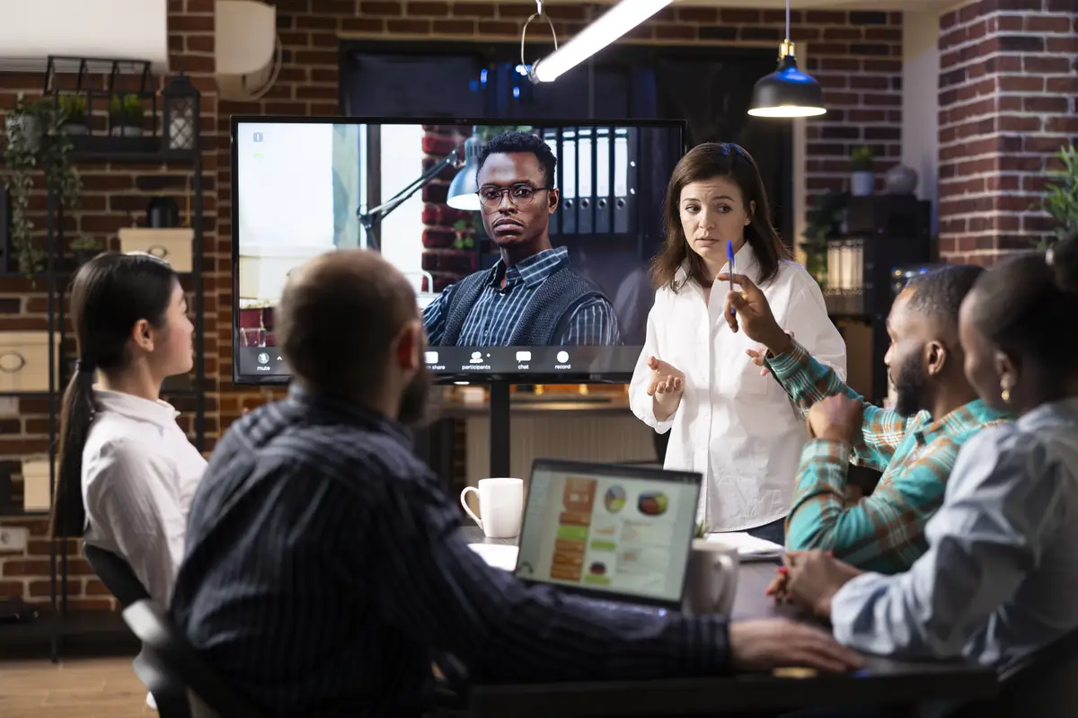 Startup team in meeting with remote manager