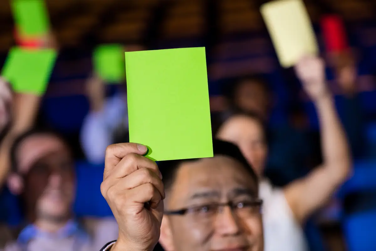 Business executives show their approval by raising hands