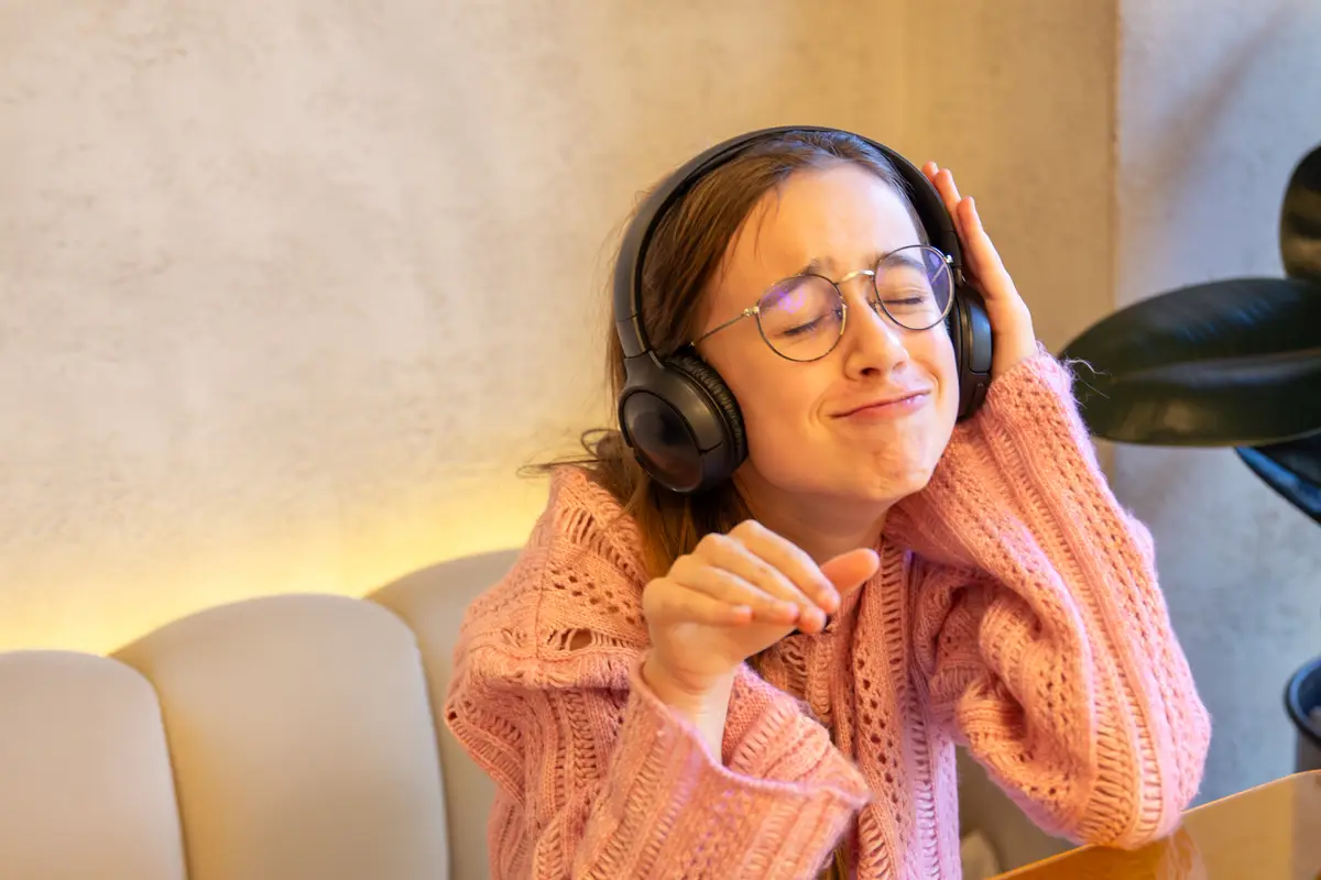 Happy teenage girl in headphones listening to music Emotions concept