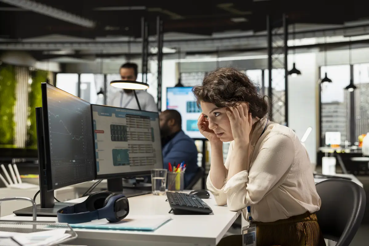 Stressed sad female consultant looks at stock crash trends market fall and worrying about a