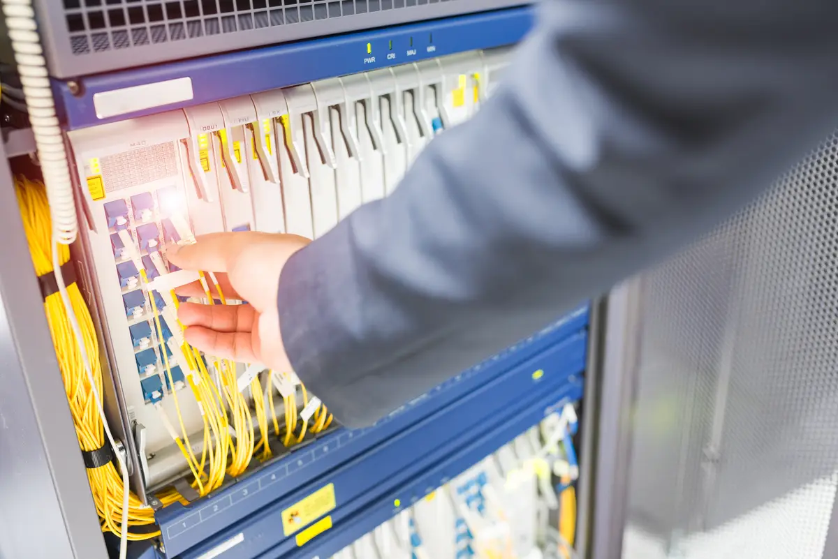 Person pulling a cable from the server