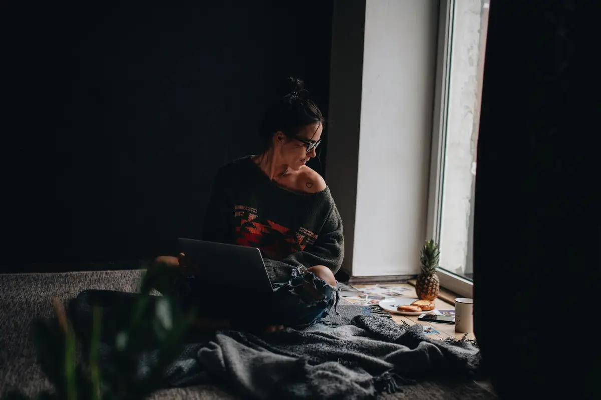Woman looking away while sitting at home