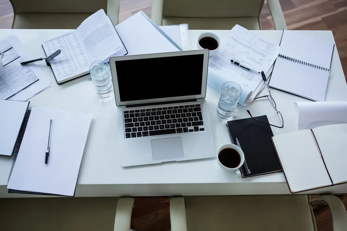 Laptop, organizer and tea on table