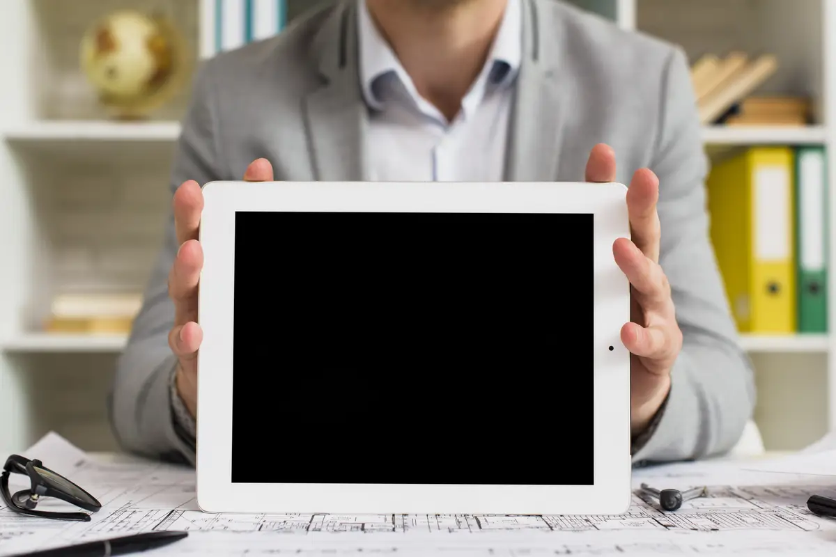 Front view businessman holding tablet mock-up