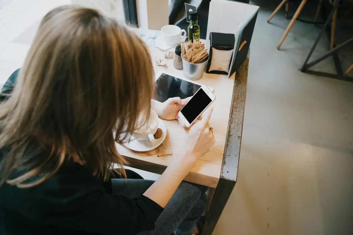 Woman using smartphone with black screen