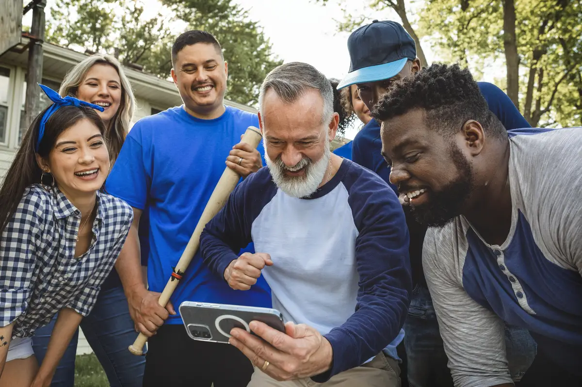 Baseball supporters watching their team win the game on a mobile phone