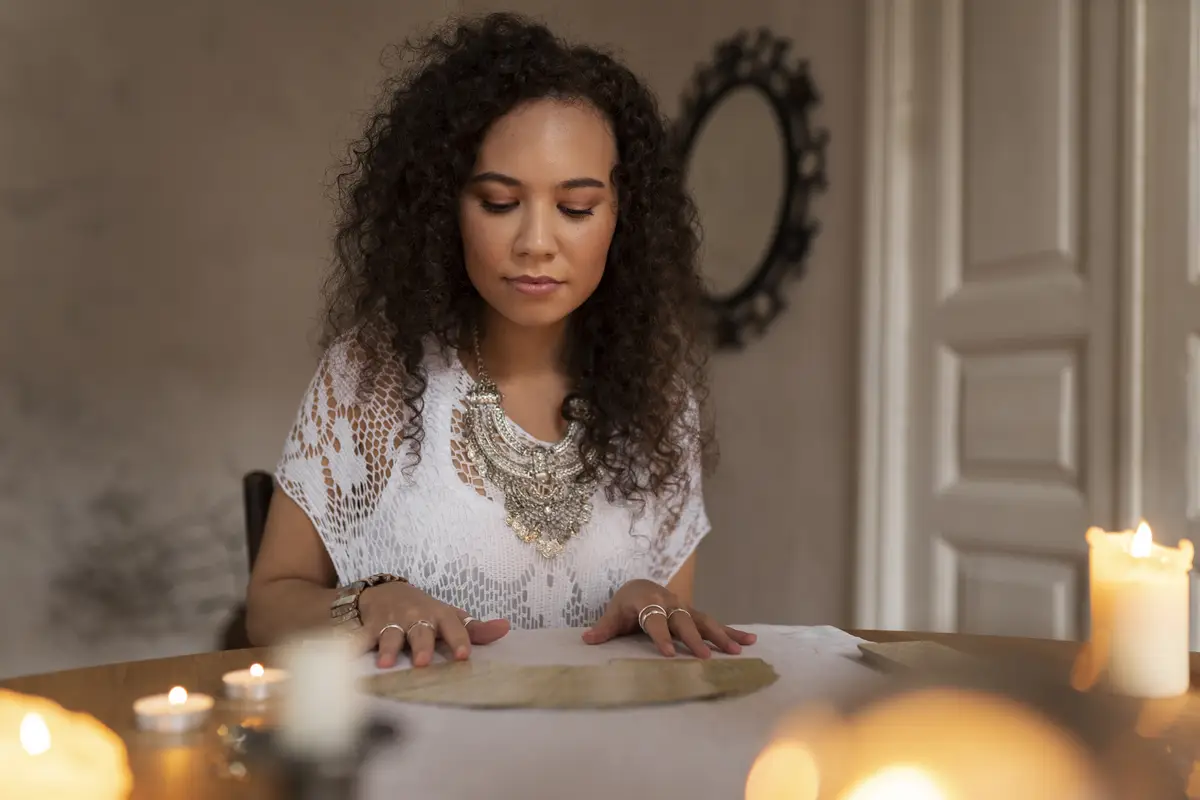 Medium shot woman reading tarot at home