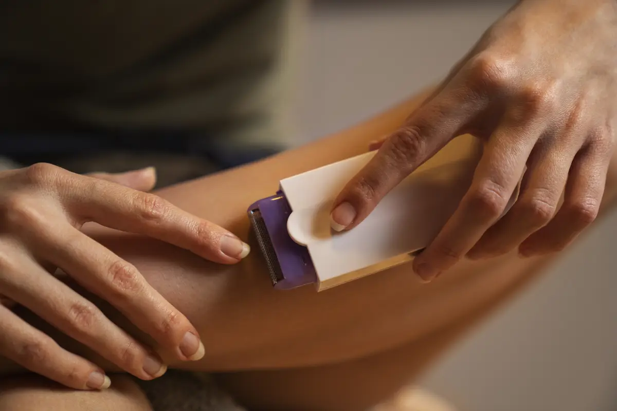 Front view woman shaving leg