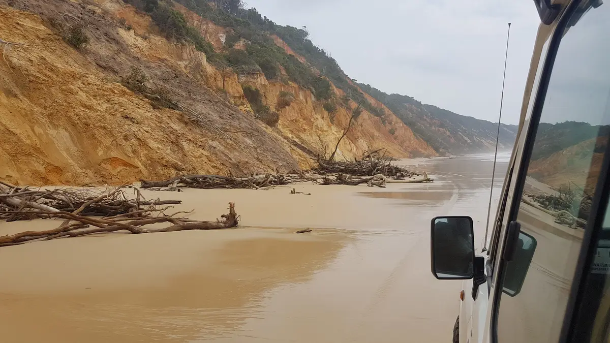 Scenic view of land and mountains against sky