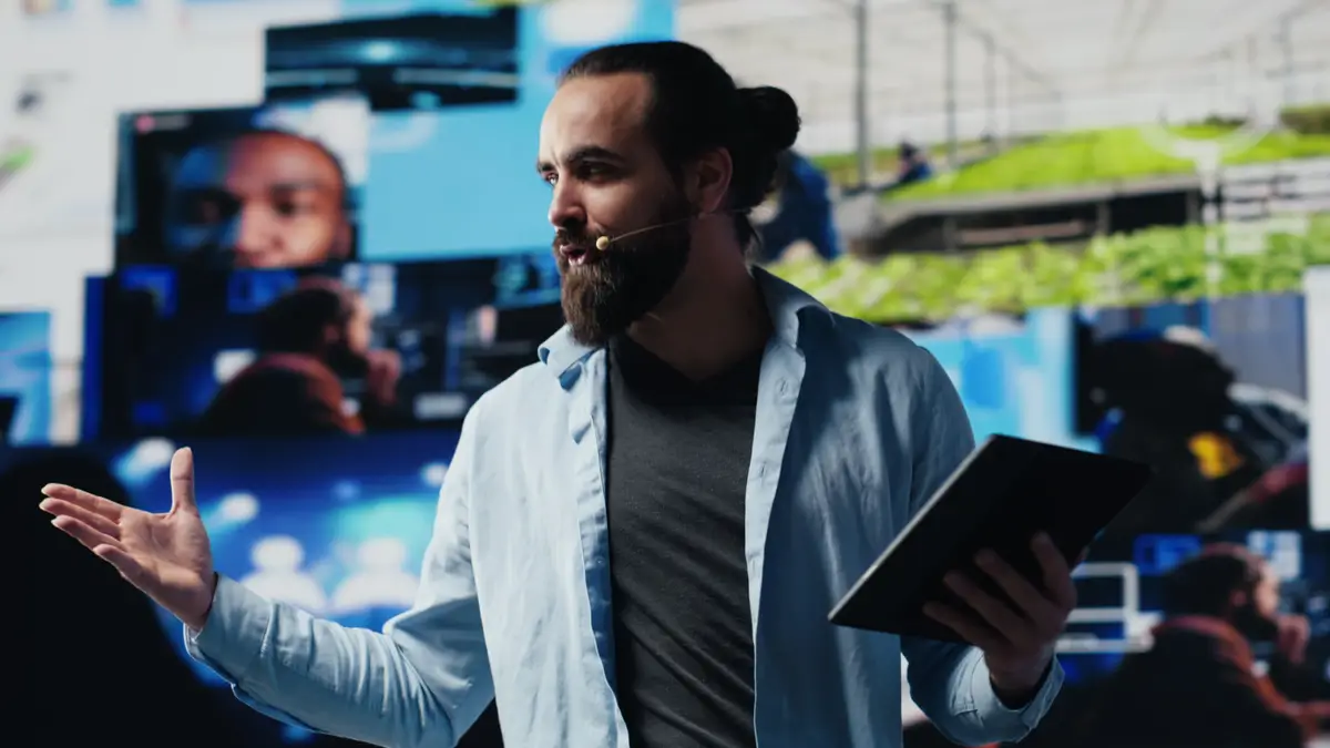 Male cool IT expert hosting a live convention with hands free microphone