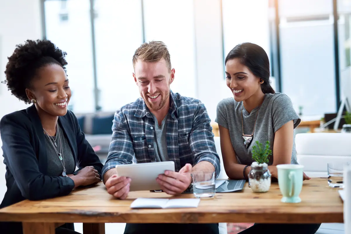 Coworking office and planning on tablet with help from teamwork and support of creative web developer Reading online and business people with seo market research on social media and website