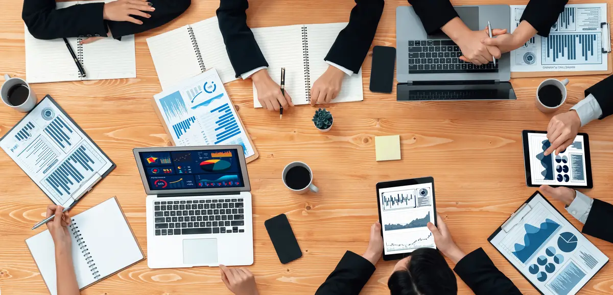 Business team of financial data analysis meeting report paper in harmony office