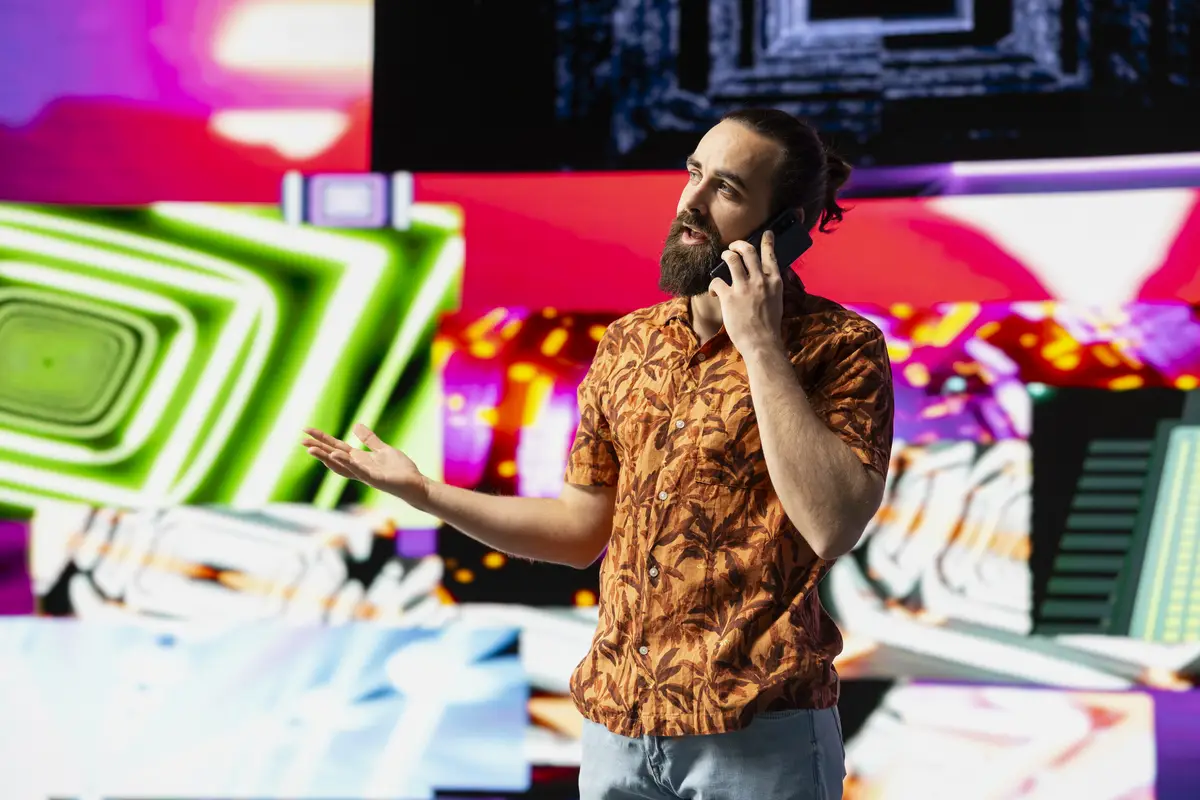 Stylish vlogger and DJ answers a phone call under vibrant neon lights