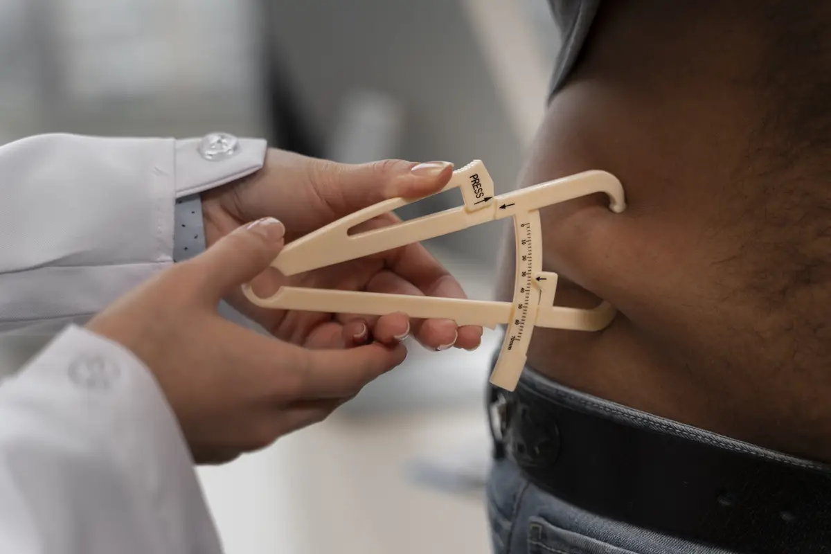 Front view doctor using adipometer