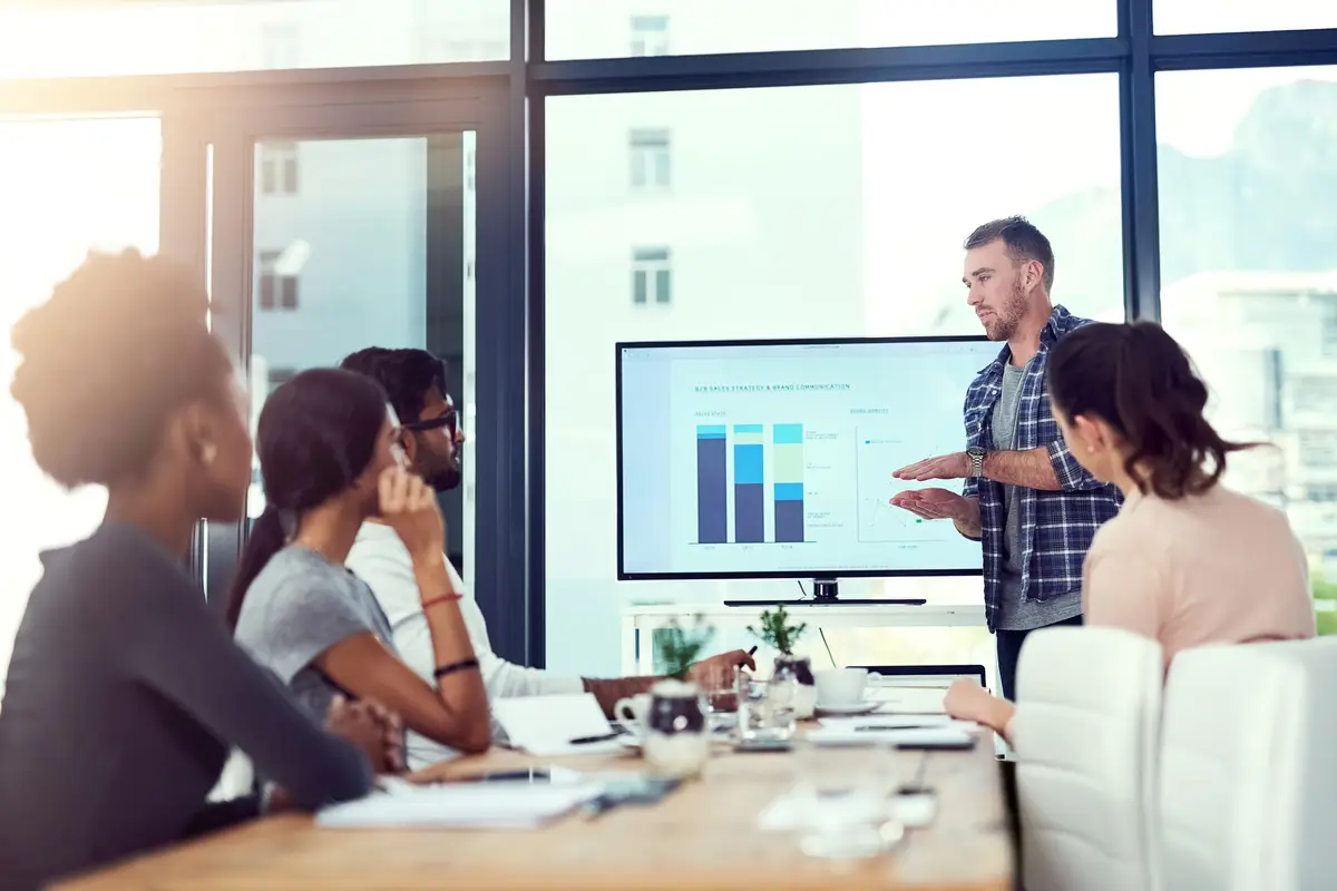 Delving into the numbers Cropped shot of a young man giving a presentation to his team