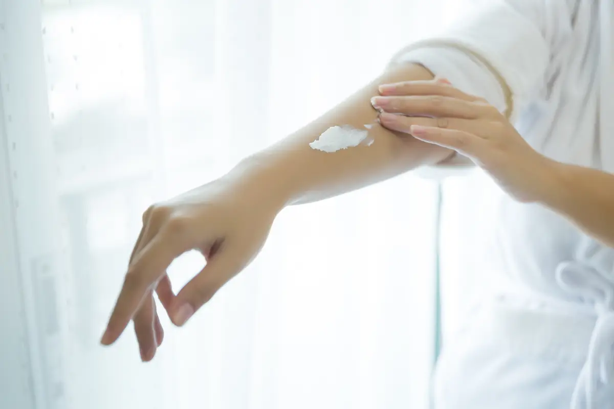 woman holds a jar with a cosmetic cream in her hands