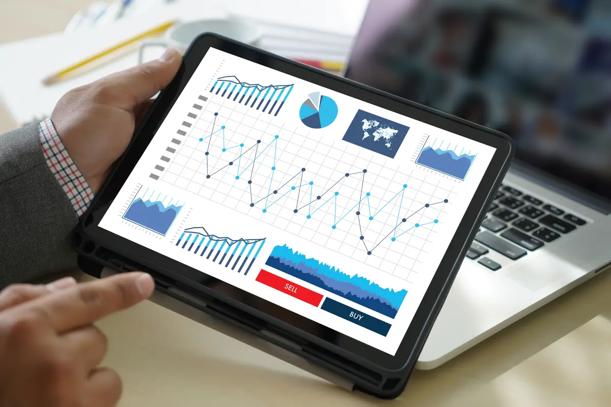 Cropped hands of businessman using digital tablet in office