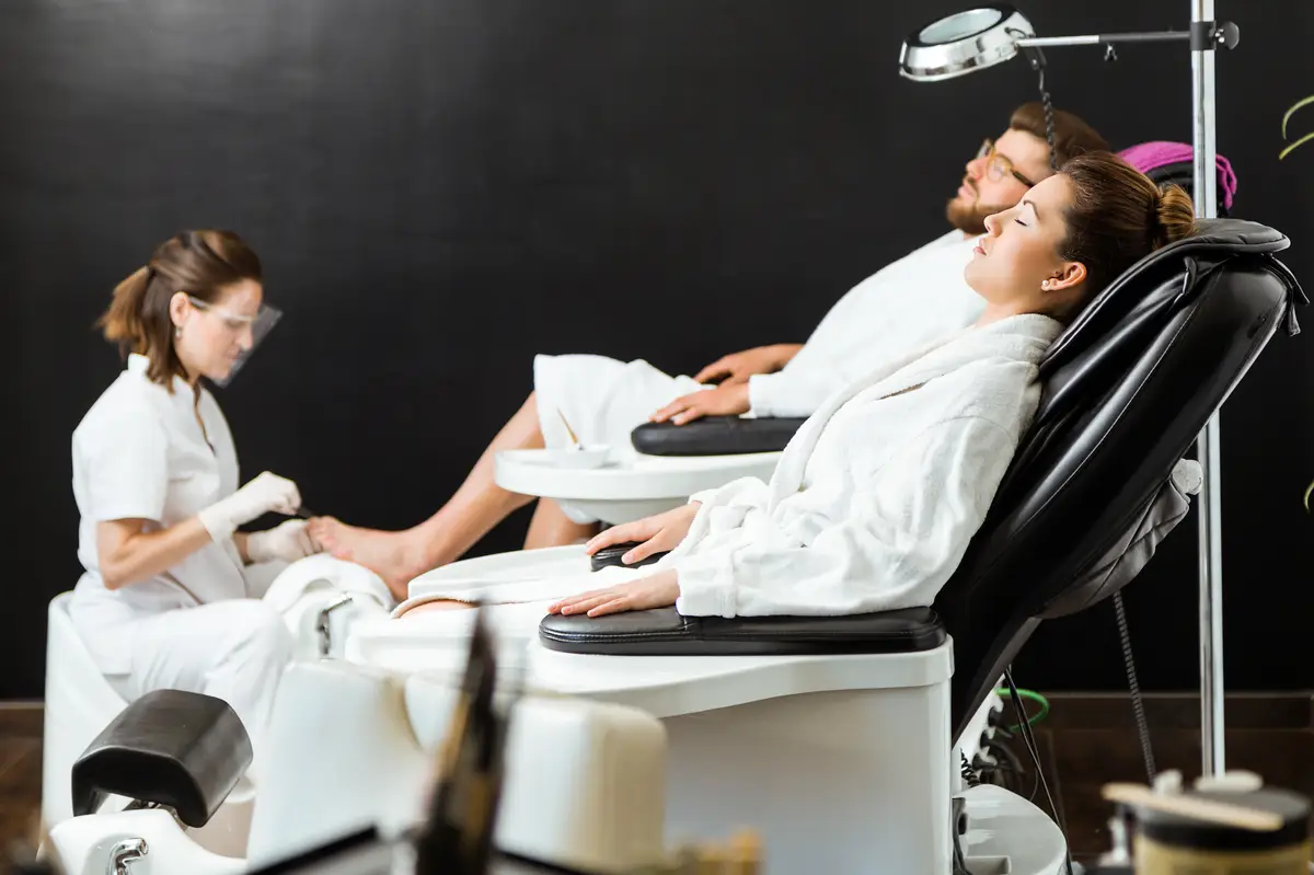 Young man doing pedicure in salon. Beauty concept.