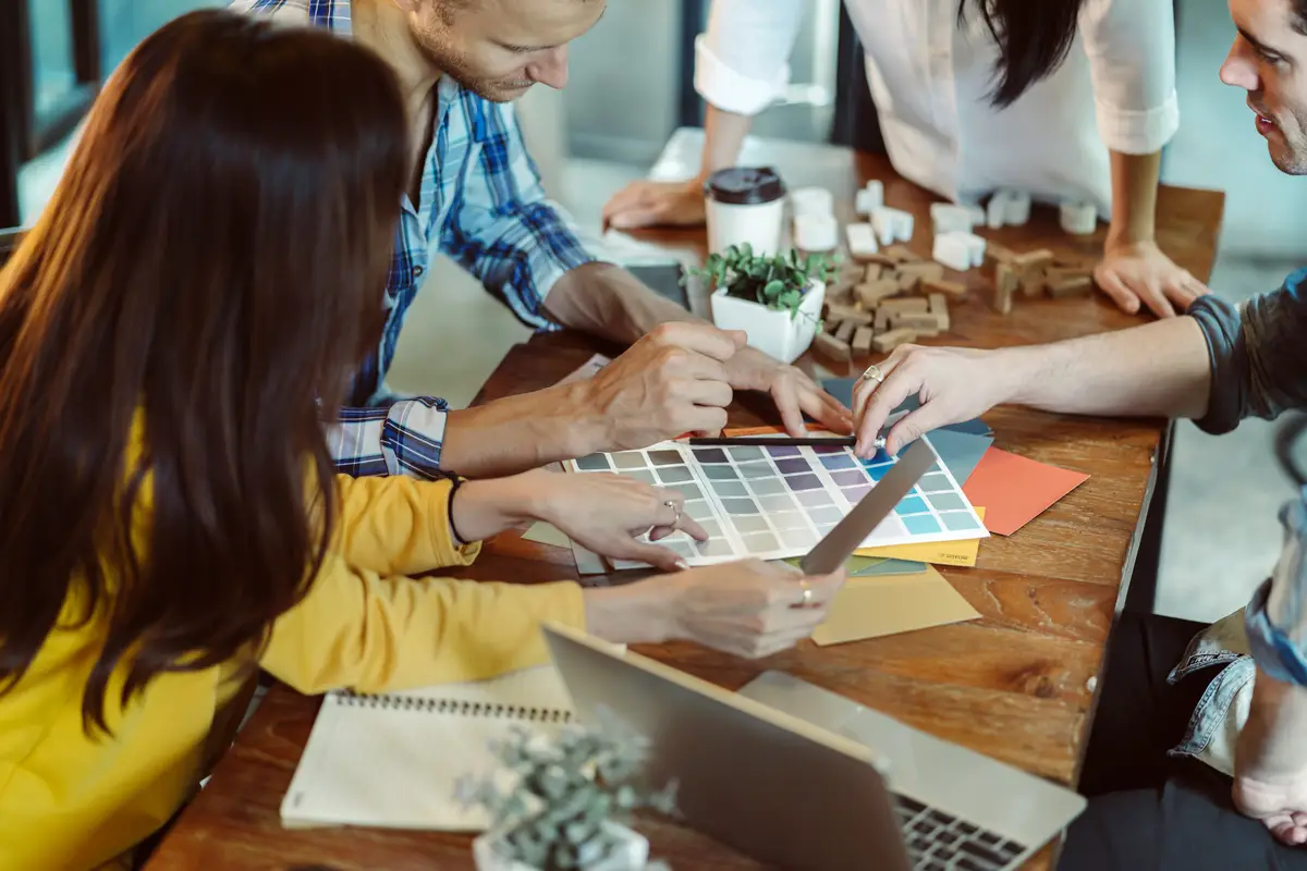 Creative business meeting with caucasian and asian co worker discuss with paper laptop and happiness and joyful cafe background
