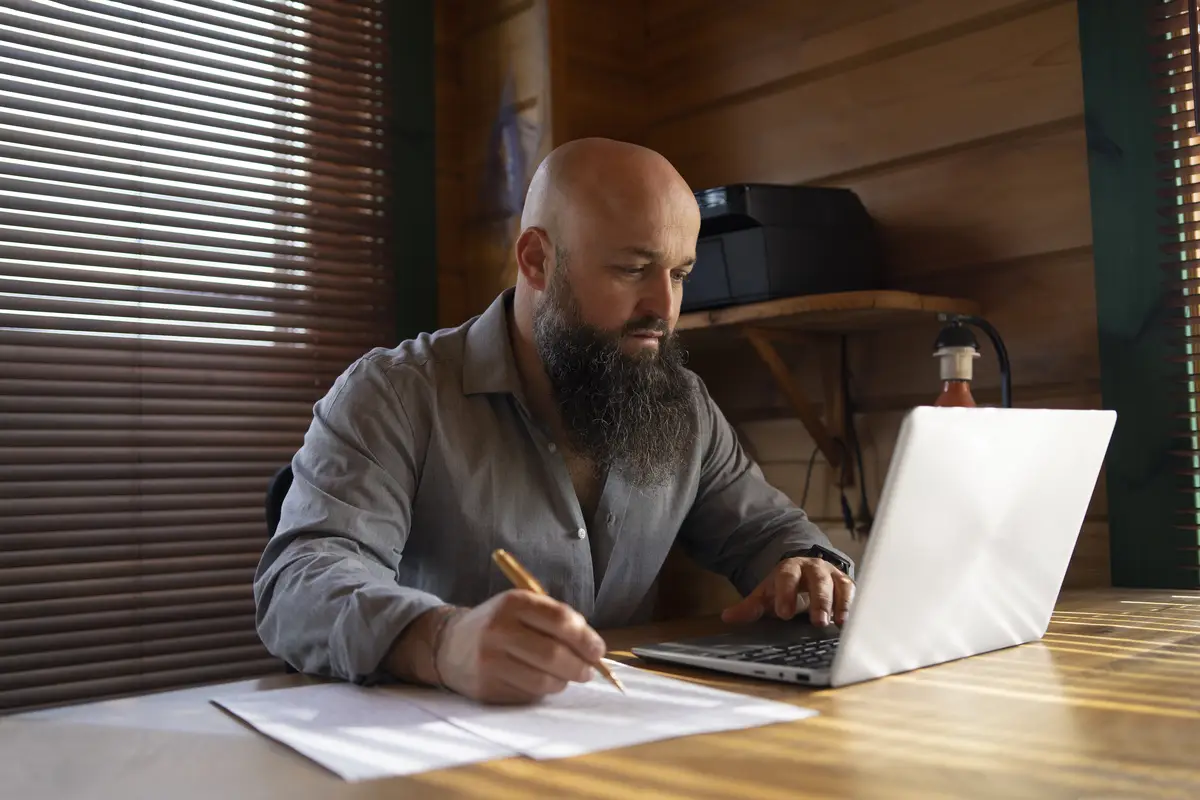 Medium shot man working on laptop