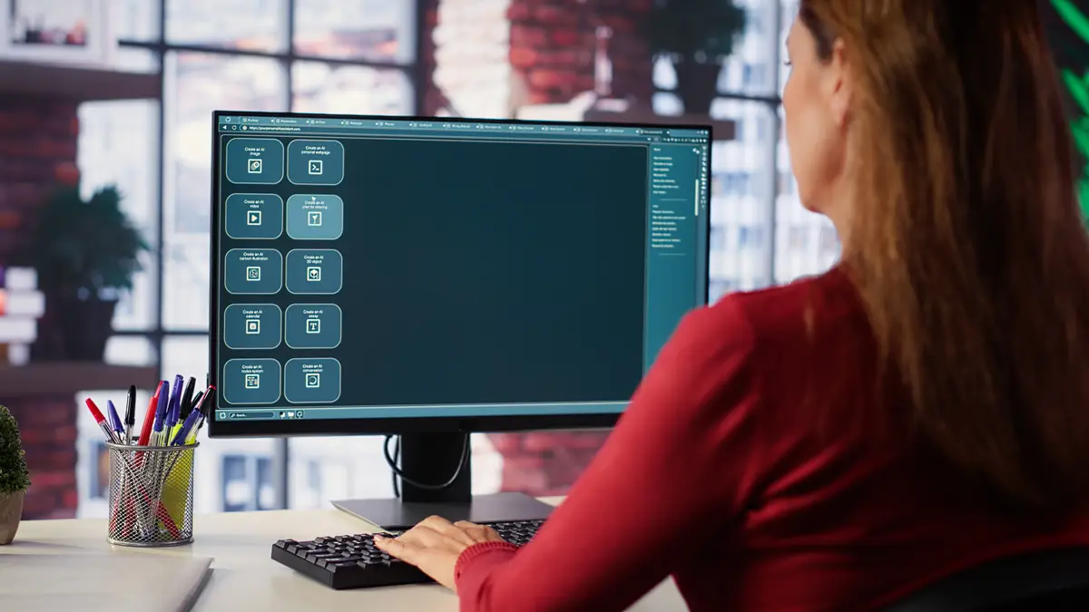 Focused woman working with an AI chatbot on her desktop computer