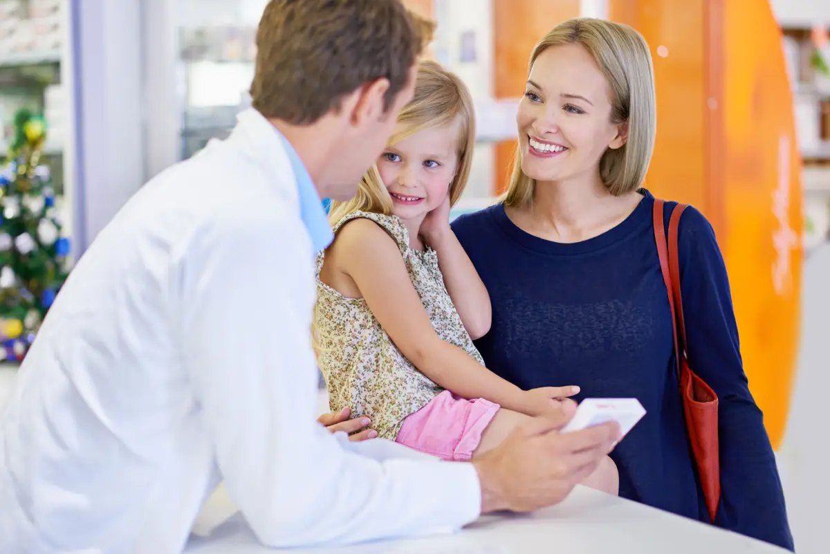 Pharmacist mother and girl with medicine in store for healthcare wellness and advice for people Pills mom and daughter with box supplements or retail discount for pharmaceutical product at shop