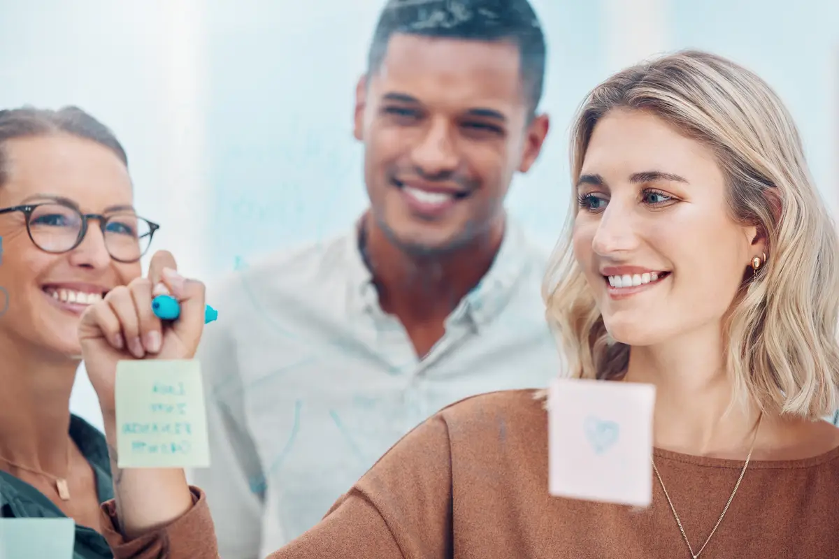 People meeting in office sticky notes with business teamwork and creative company planning strategy Happy employee group brainstorming schedule project research and workshop ideas for our vision