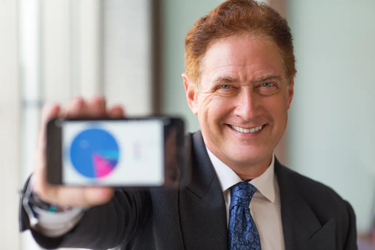 Cheerful business leader showing statistics