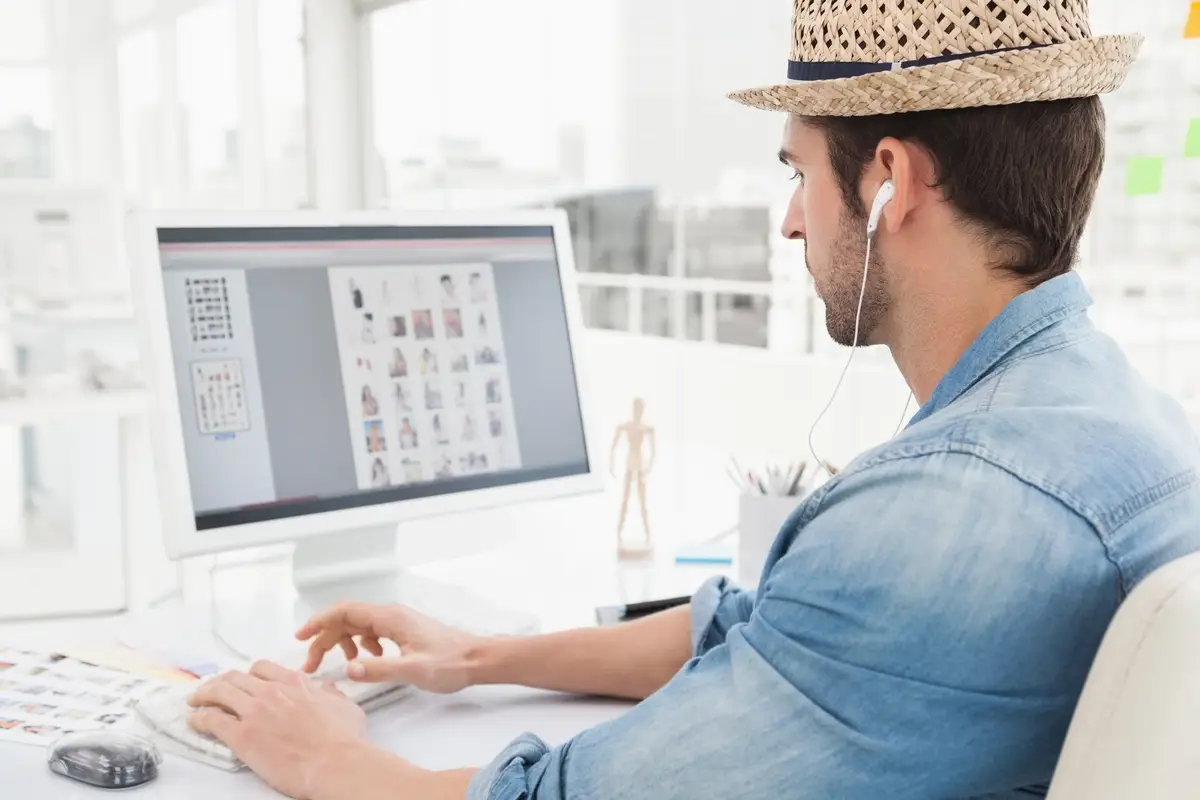 Serious businessman listening music and typing on keyboard