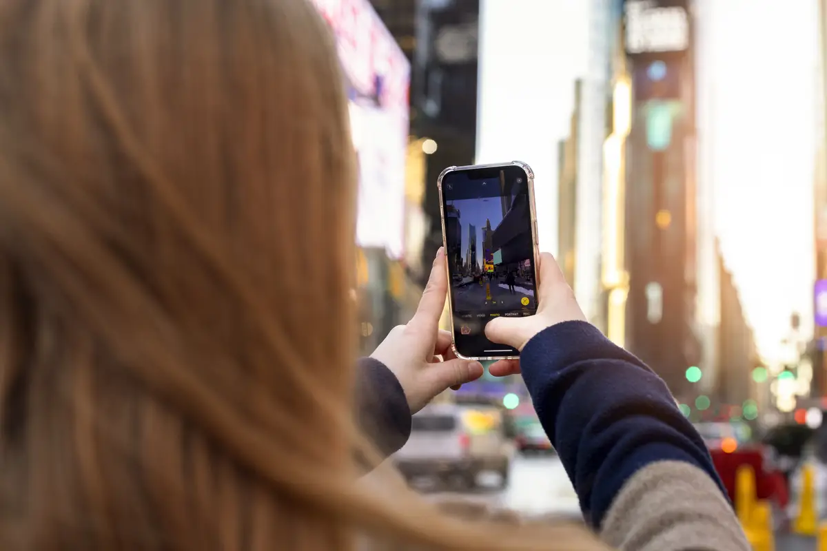 Young woman taking picture of new york city during daytime
