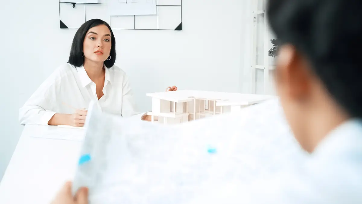 Project manager puts the map on table while discuss with coworker Immaculate