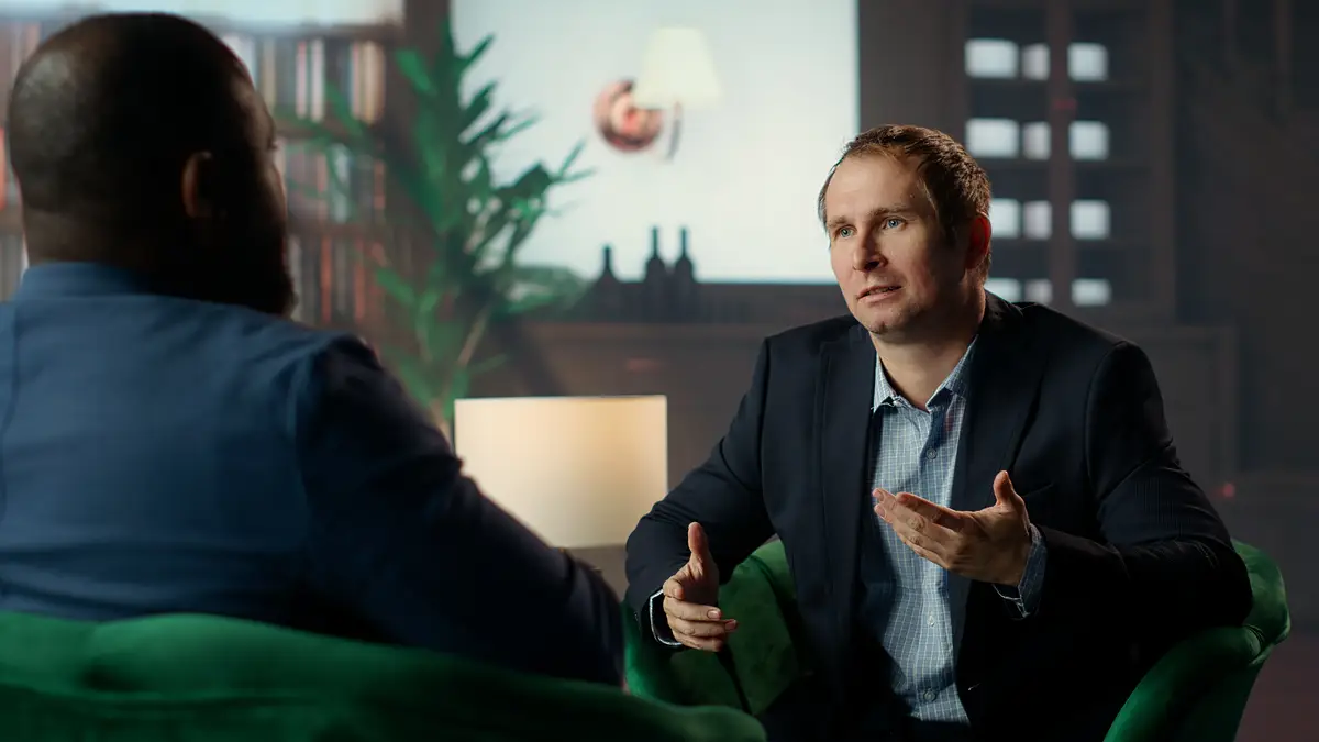 Two diverse gentlemen in private classy social club discuss career advancement