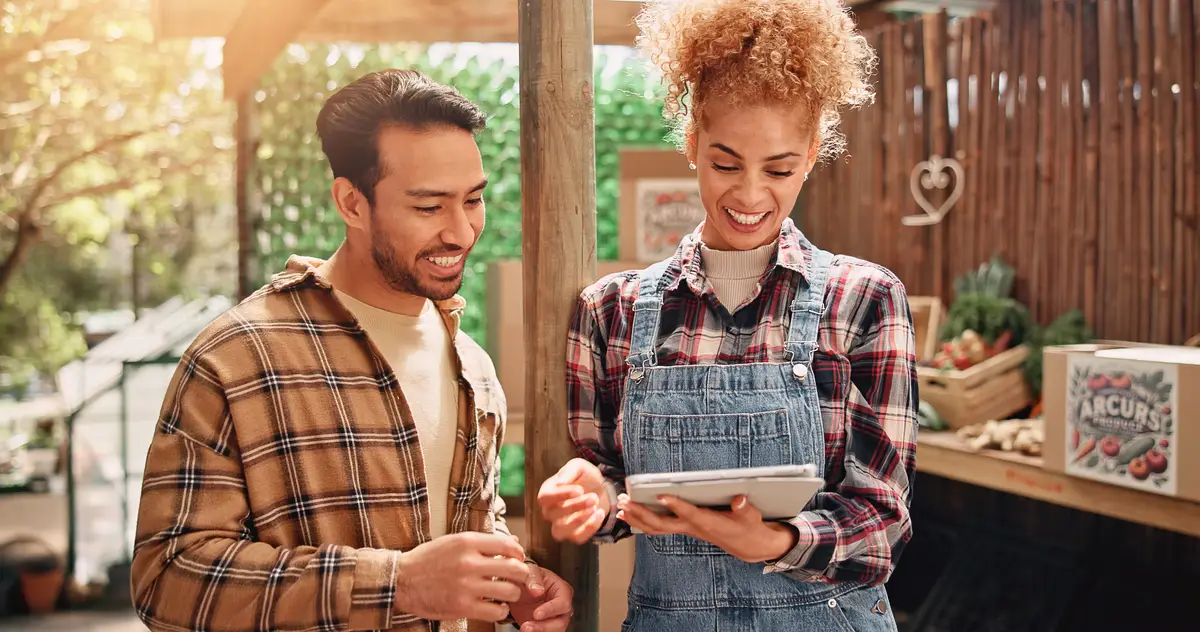 Small business man and woman with tablet vegetables and checking for sales on website smile and team Shop entrepreneur and people with tech for online order happy and store with healthy food