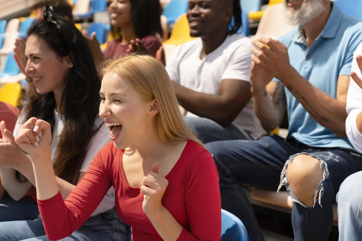 People looking at a football game in a sunny day
