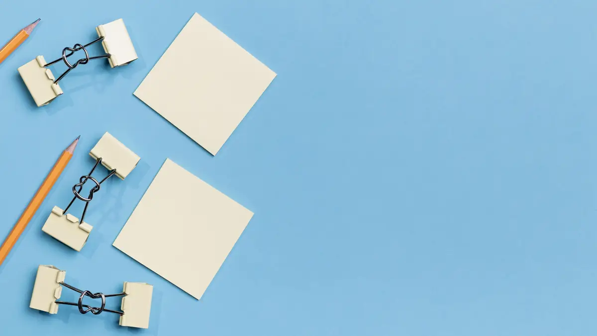 Top view paper clips and pencils with copy space