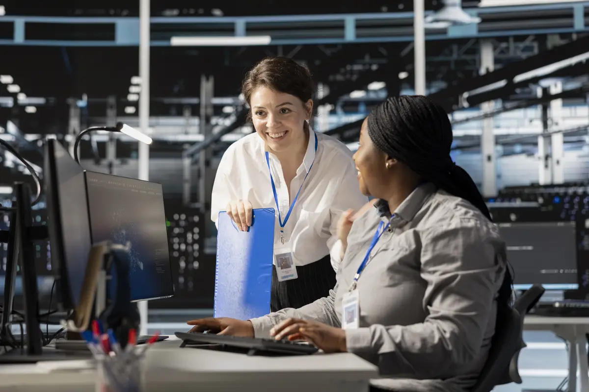 Teamworking colleagues in server hub pleased after successful operations