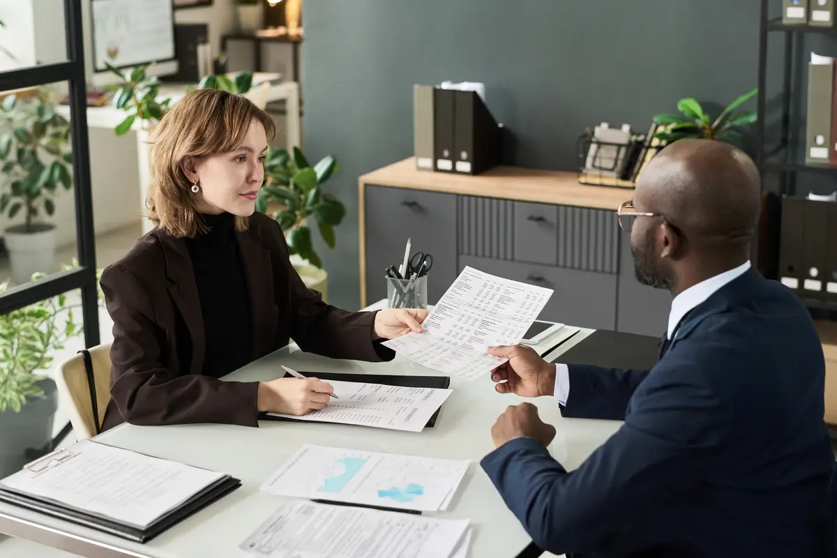 Colleagues making analysis of finance in team