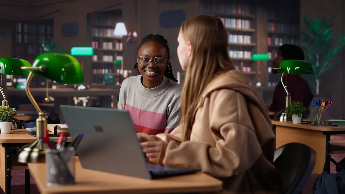 Female student reading and writing detailed notes for an exam