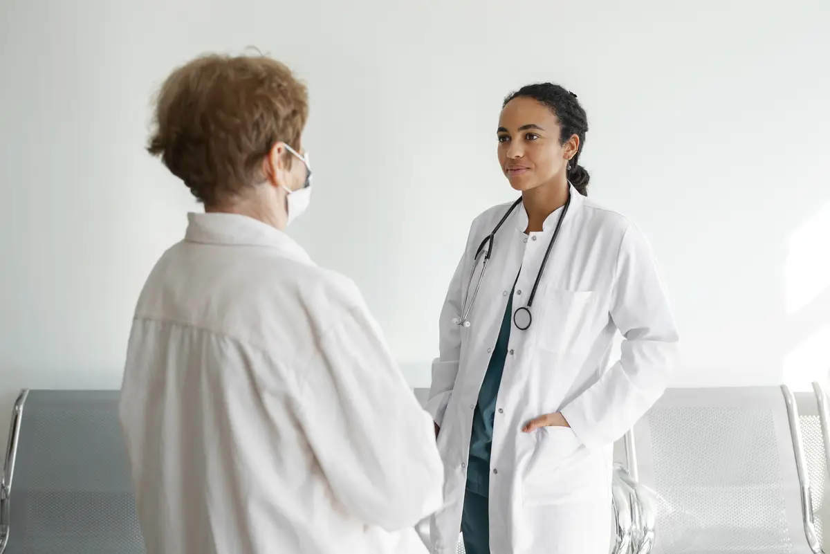 Side view doctor talking to patient