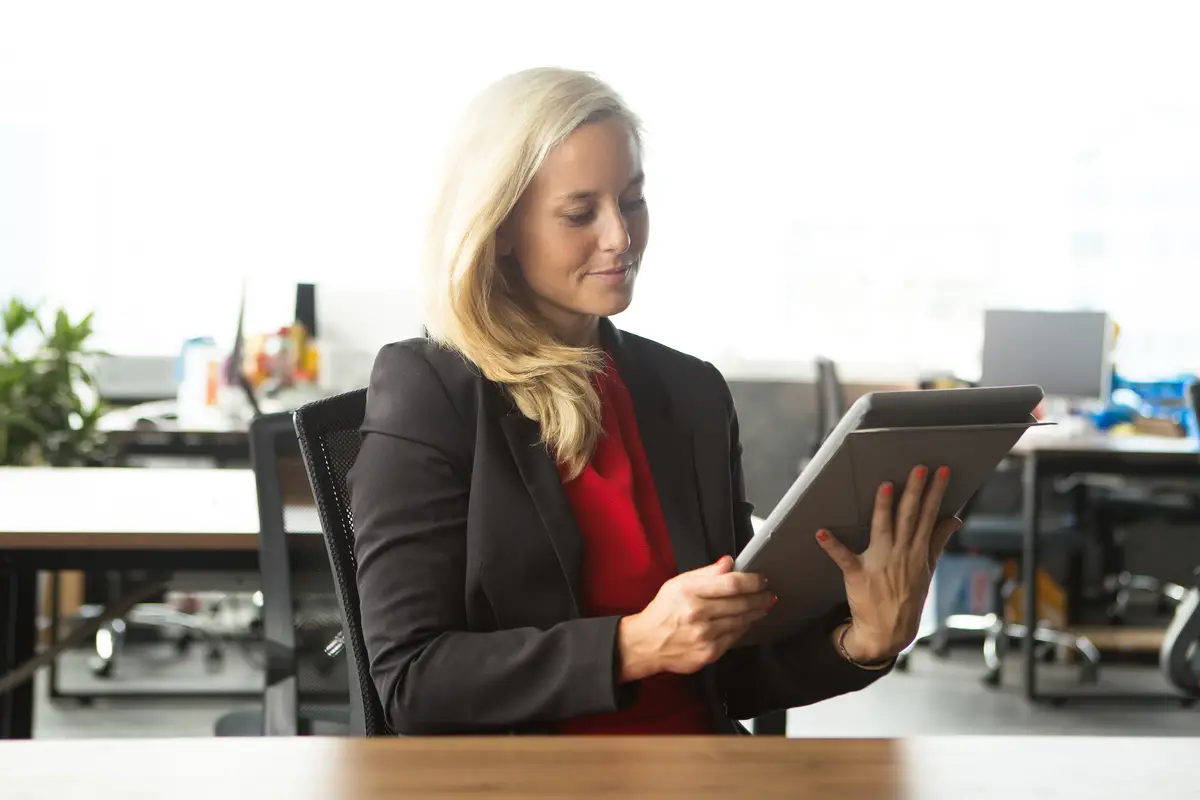Confident young businesswoman using touchpad