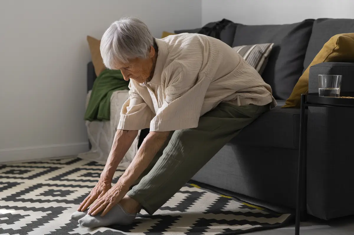 Portrait of senior woman stretching at home