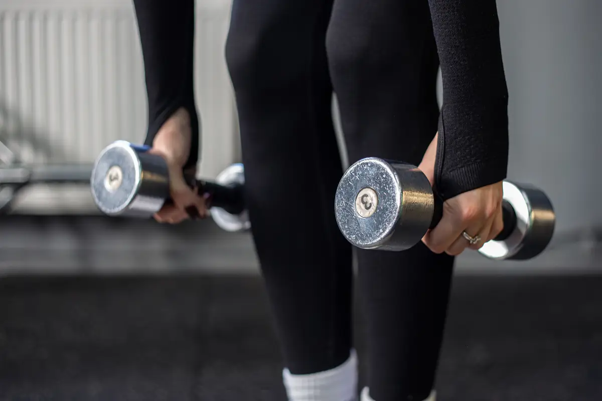 Young woman in the gym Dumbbells in gym workout Gym