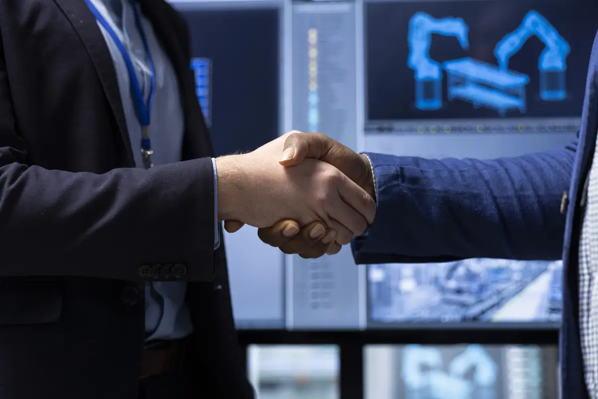 Investor shaking hands with factory manager after finding no issues closeup