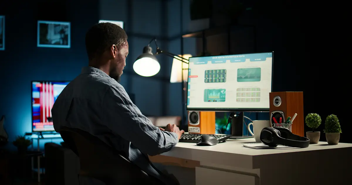 African american investment expert works at home analyzing financial statistics